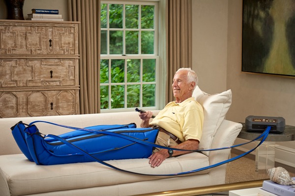 a man sitting on a couch with a blue inflatable tube